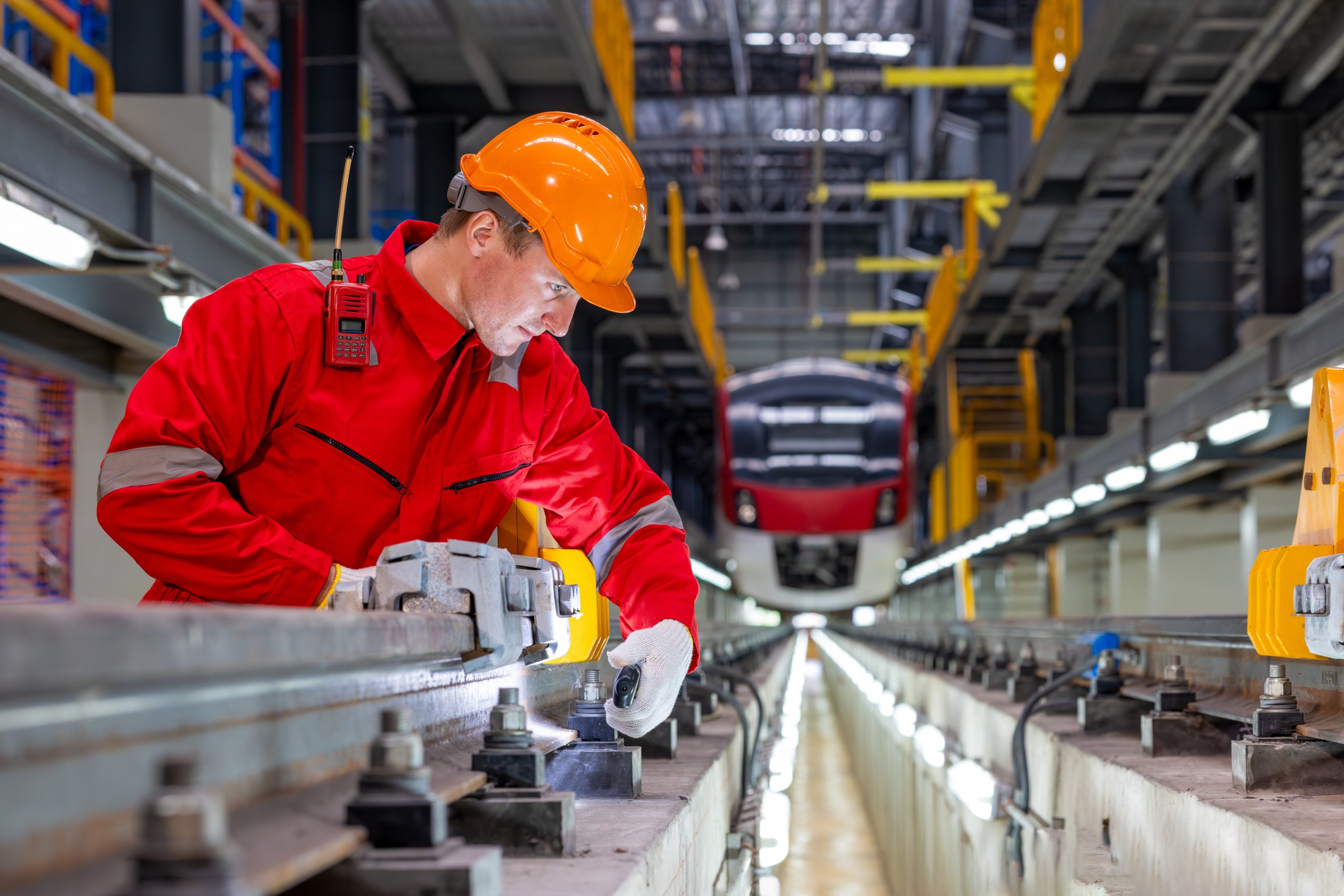 Electric train technician engineer checking controls system for security functions in maintenance infrastructure plant of sky train, public transportation vehicle,Teamwork management concept.